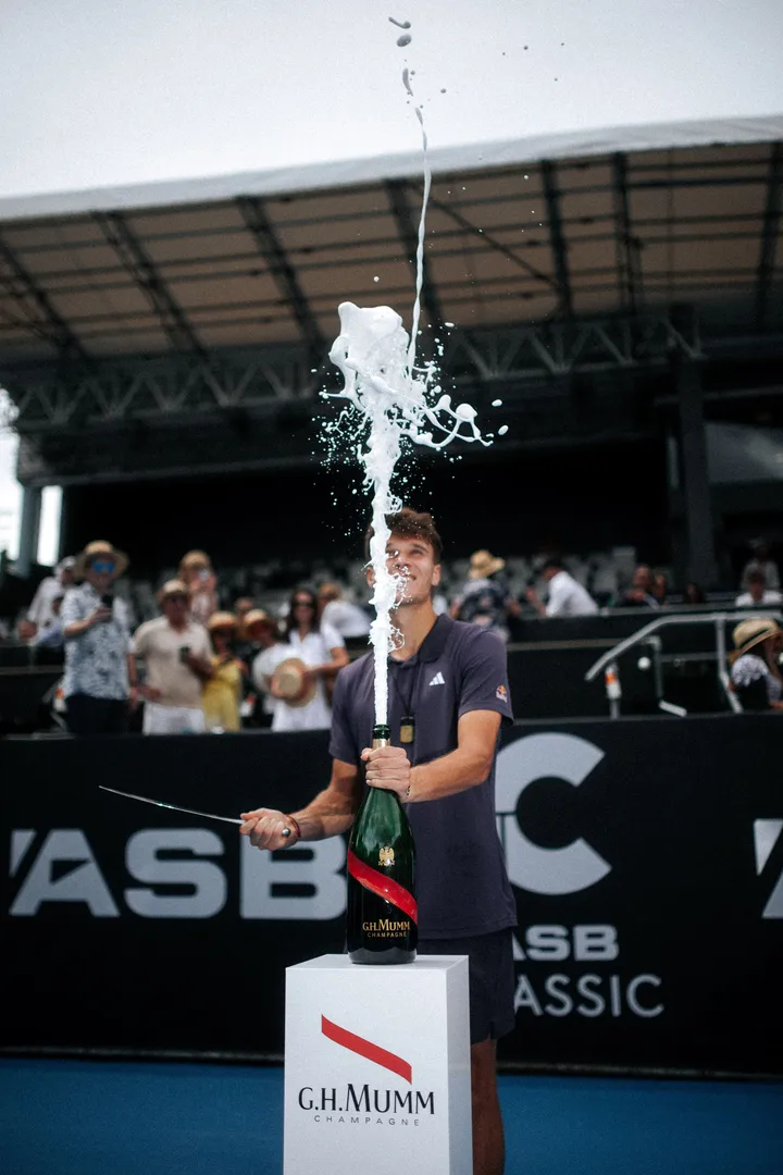 ASB Classic champion celebrating with a trophy